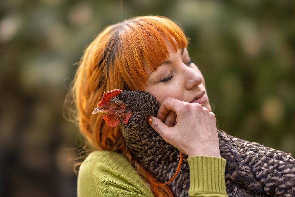 Young 30 year old woman with her emotional support chicken. 