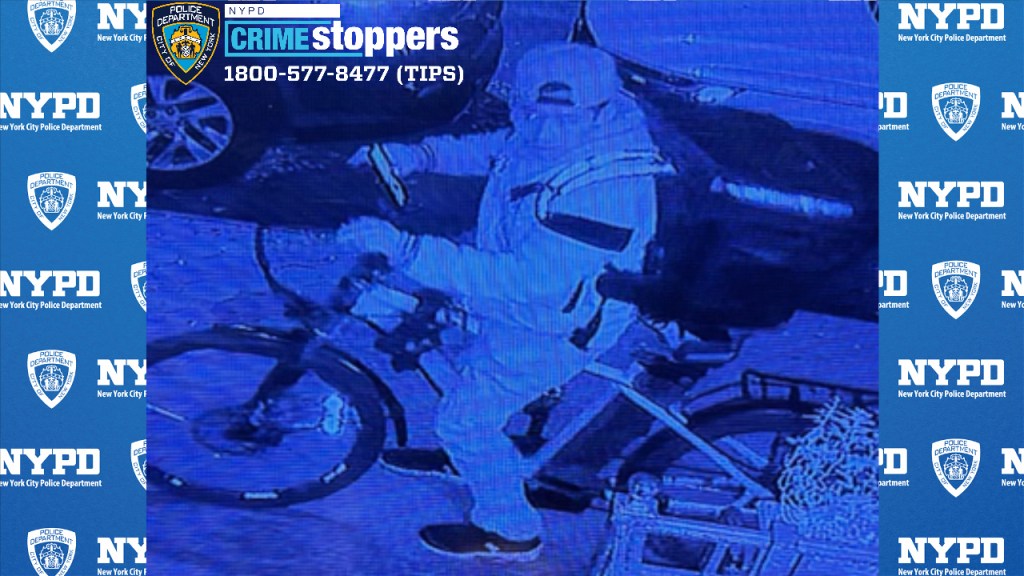 Photo shows a man on a bicycle.