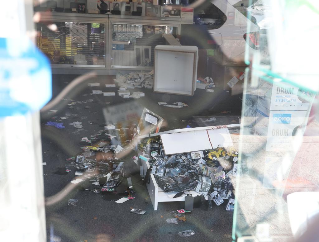 Crime scene at Top in Town wireless store with disarray from a robbery and shooting, victim Kunwarjee Singh recovering
