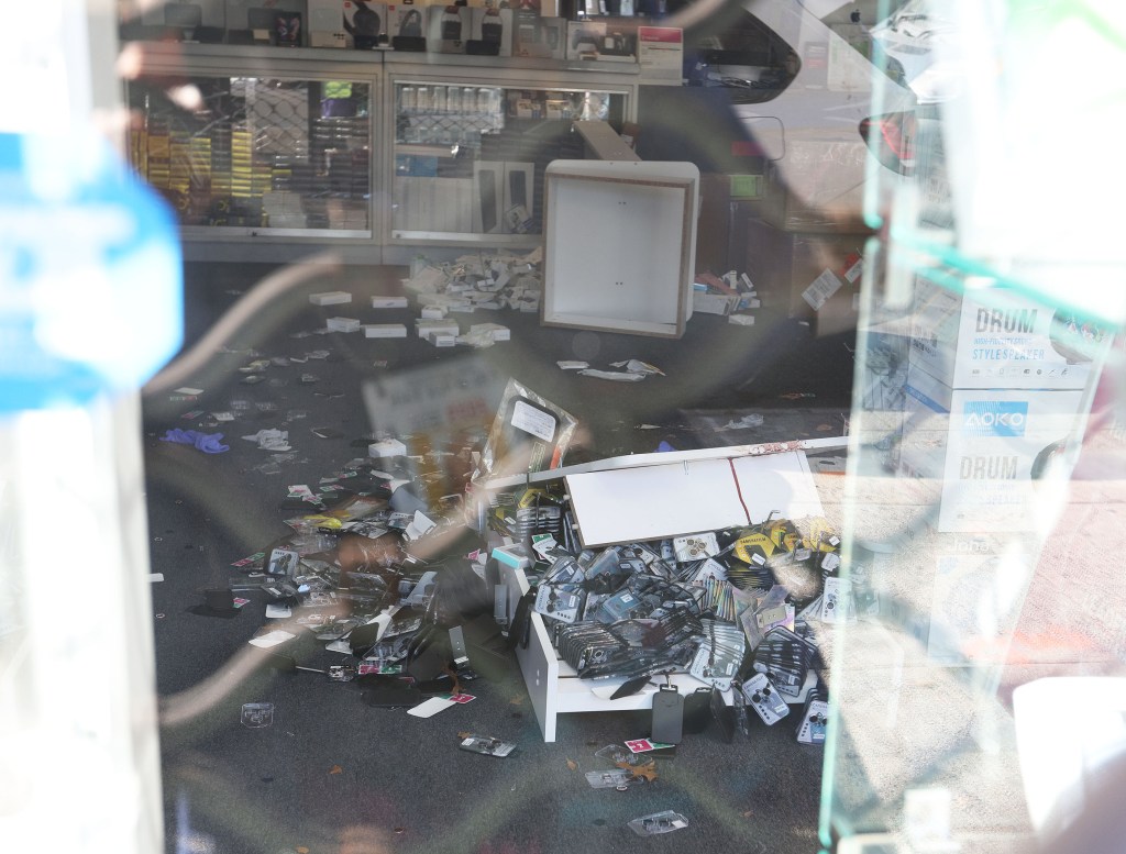 Crime scene at Top in Town wireless store with disarray from a robbery and shooting, victim Kunwarjee Singh recovering