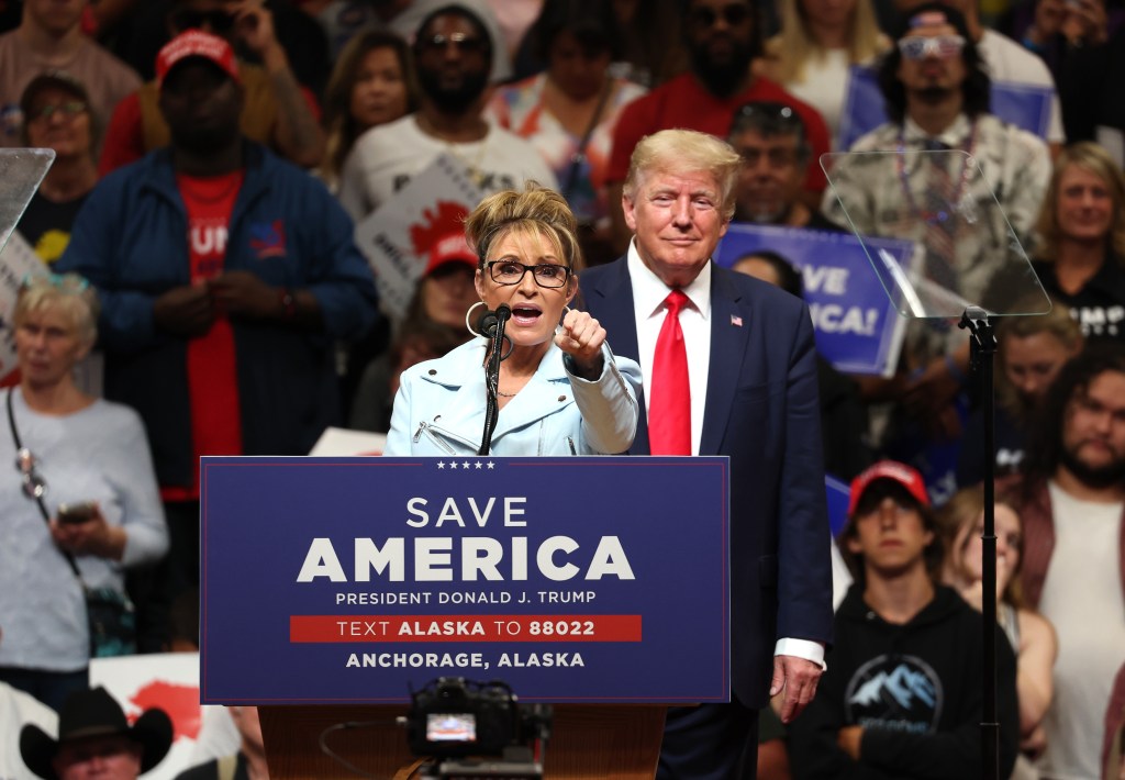 Sarah palin at Trump rally, pointing to audience from behind podium