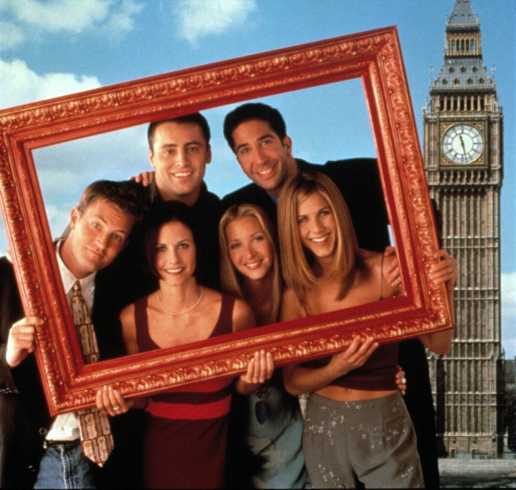 A promo shot from Friends with the cast holding up a picture frame and Big Ben in the background