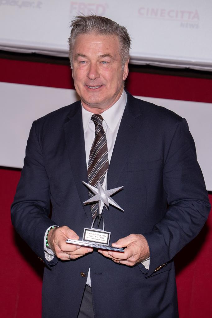 Alec Baldwin holding an award