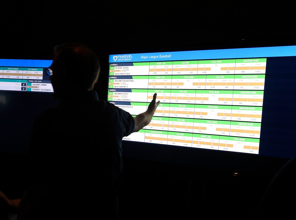 Man looks at stats on baseball on a computer screen on opening day of FanDuel Sportsbook sports betting at the Meadowlands Raceway.
