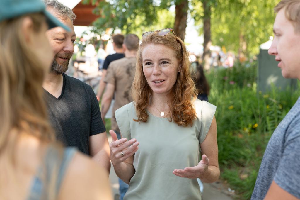 Democrat Rebecca Cooke, a candidate for a Wisconsin House seat, in conversation with a man.