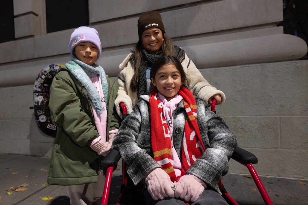 Olivia (left) with sister Alana (seated) and Mother Maria Rios