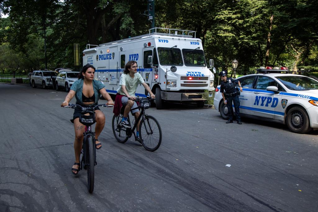 Police officers and bicyclists in Central Park.
