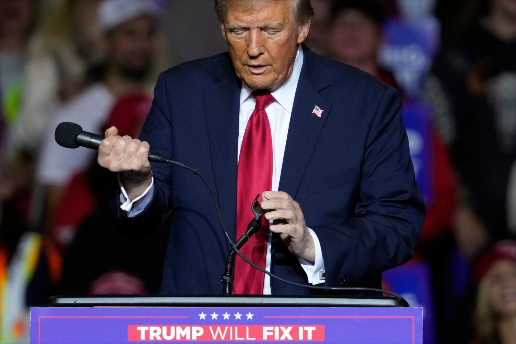 Trump removed the microphone from a stand and held it instead.