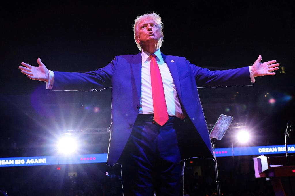 Former U.S. President Donald Trump gesturing to the crowd at his final campaign rally in Grand Rapids, Michigan