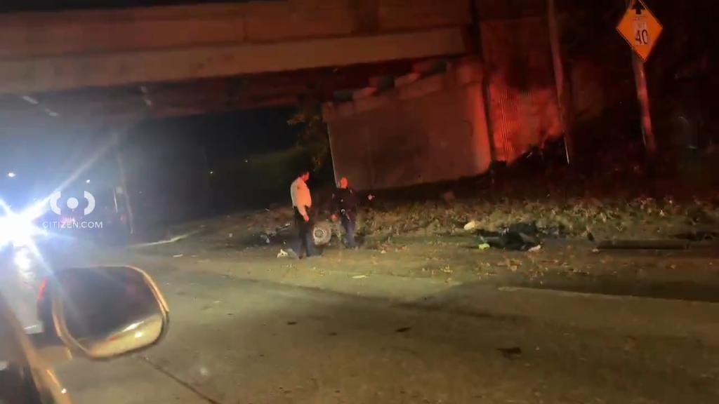 Police officers investigate the scene of the crash Wednesday. 