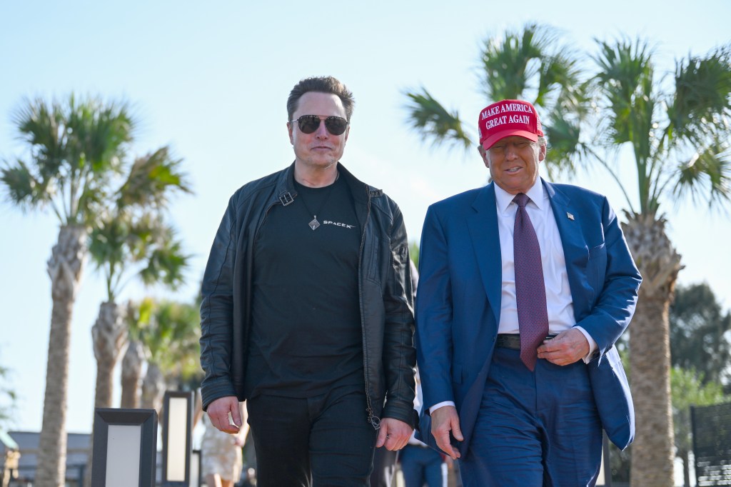 Elon Musk and President-elect Donald Trump walk together as the two attend a launch viewing for the SpaceX Starship rocket on Nov. 19, 2024.