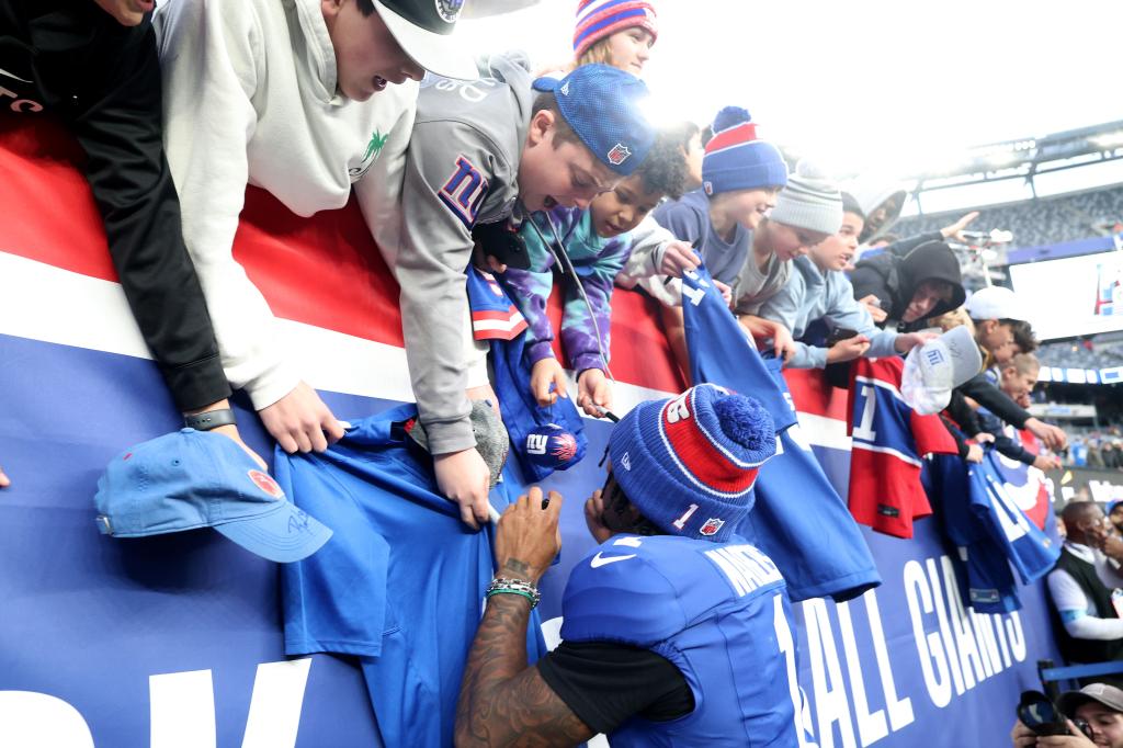 Malik Nabers signs autographs for fans after the Giants' win against the Colts on Dec. 29.