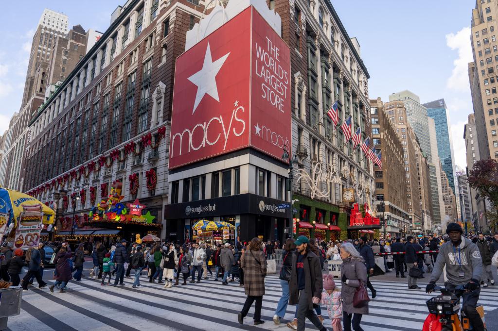 People walking past Macy's Herald Square flagship store during Black Friday sales in New York City, 2024