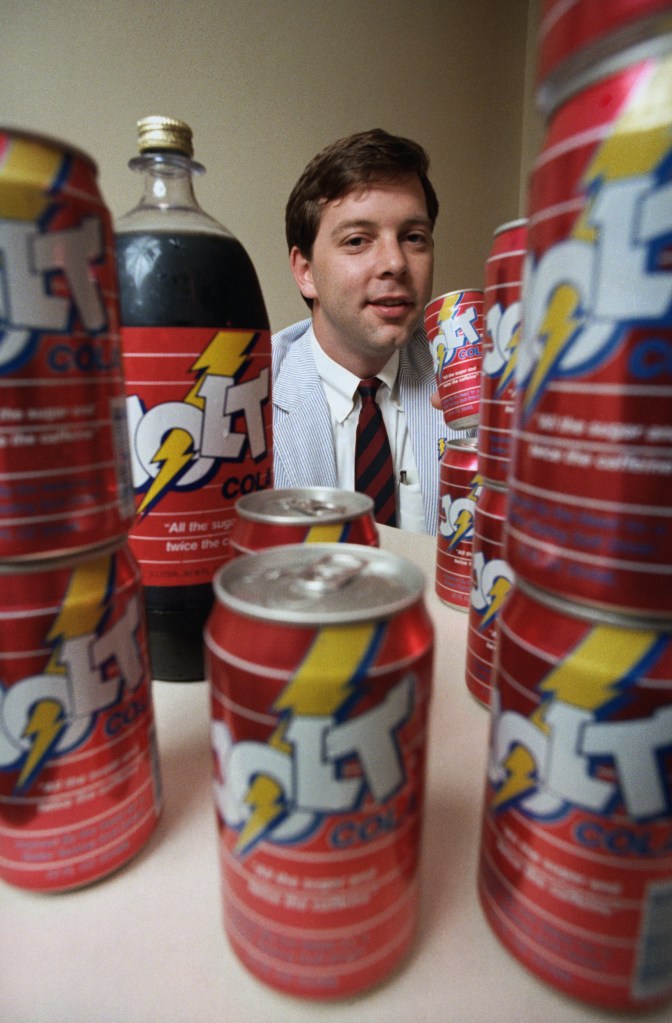 C. J. Rapp from Rochester, New York, lifting a can of his Jolt Cola invention at a distributor visit in New Orleans