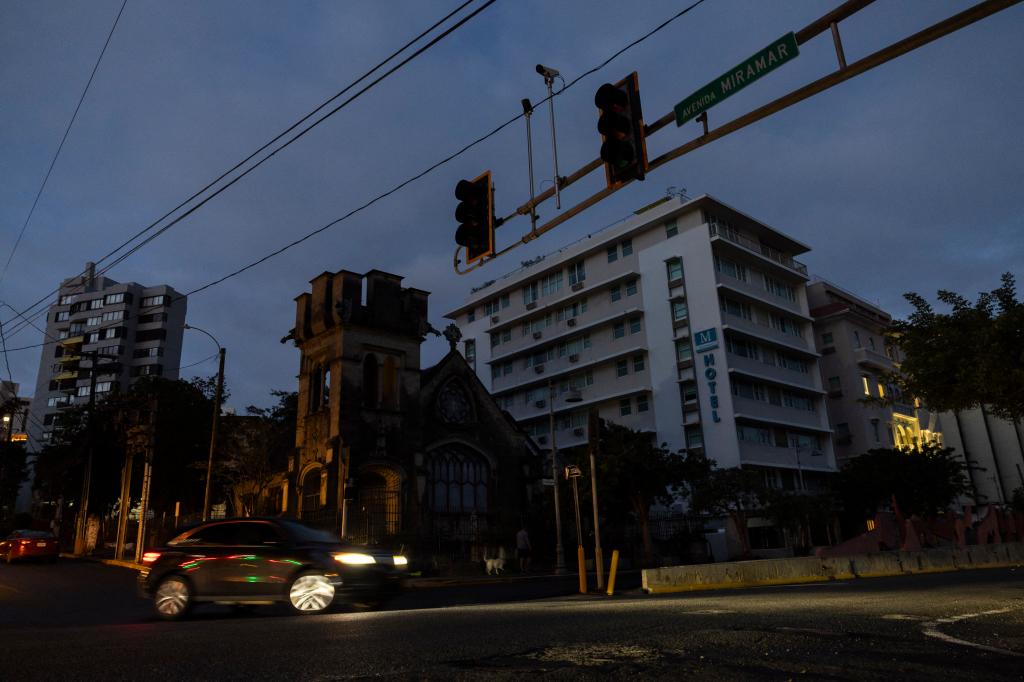 A car navigates through an intersection without stop lights in San Juan, Puerto Rico