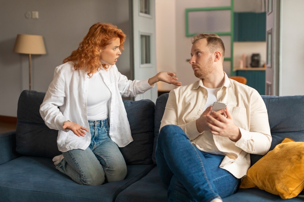 Woman looking annoyed at man