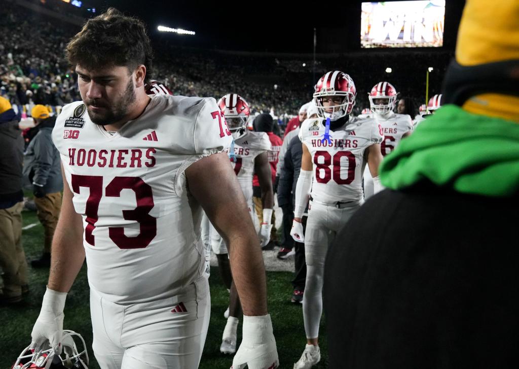 Indiana Hoosiers offensive lineman Austin Barrett (73) leaves the field along with other players after losing a game