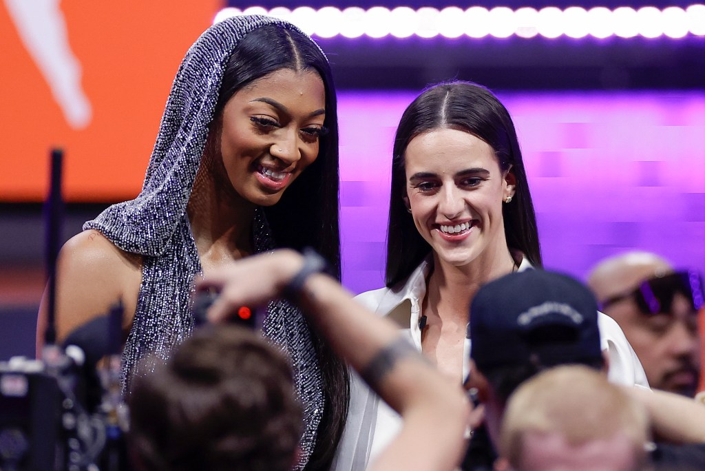 LSU's Angel Reese, left, and Iowa's Caitlin Clark, right, pose for a photo before the WNBA draft. Clark was the first overall pick. Reese was the seventh.