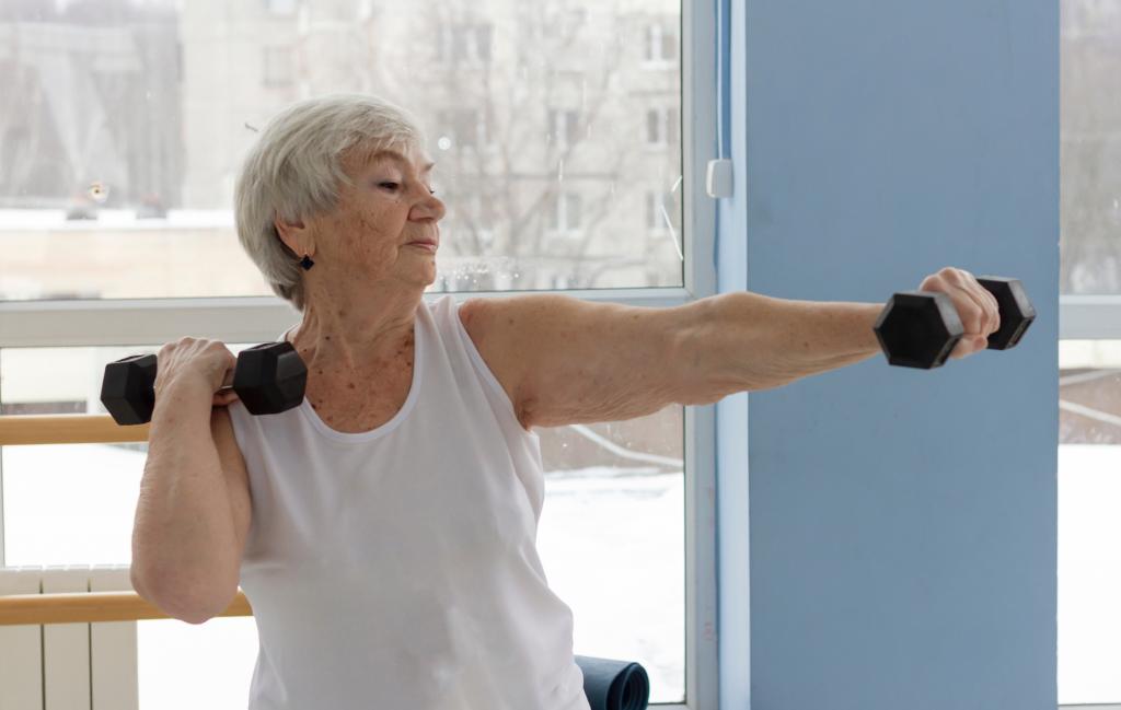 Early detection of muscle loss helps with treatment options, which includes more exercise. Here, an older woman works out with dumbbells.