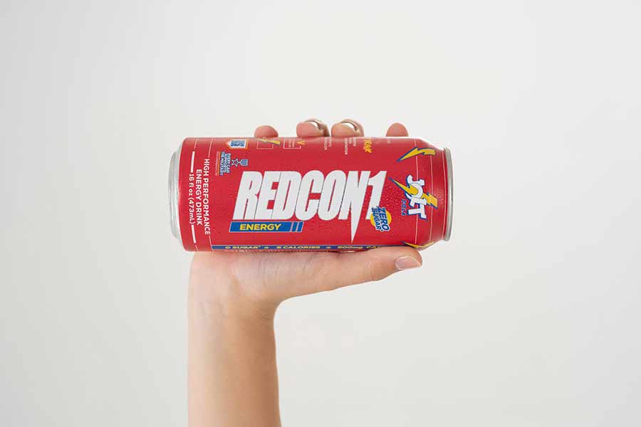 Redcon1 Jolt Cola drink in someone's hand for advertisement.