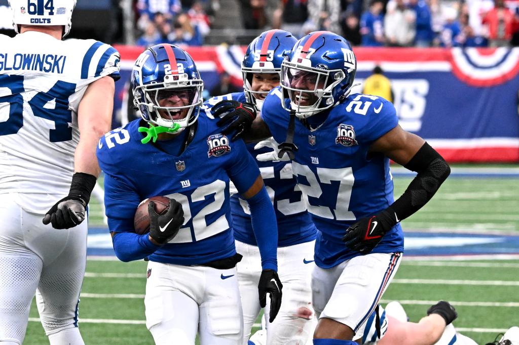 Giants cornerback Dru Phillips (22) and safety Jason Pinnock (27) celebrate an interception by Phillips during the fourth quarter of the Giants and Indianapolis Colts game.