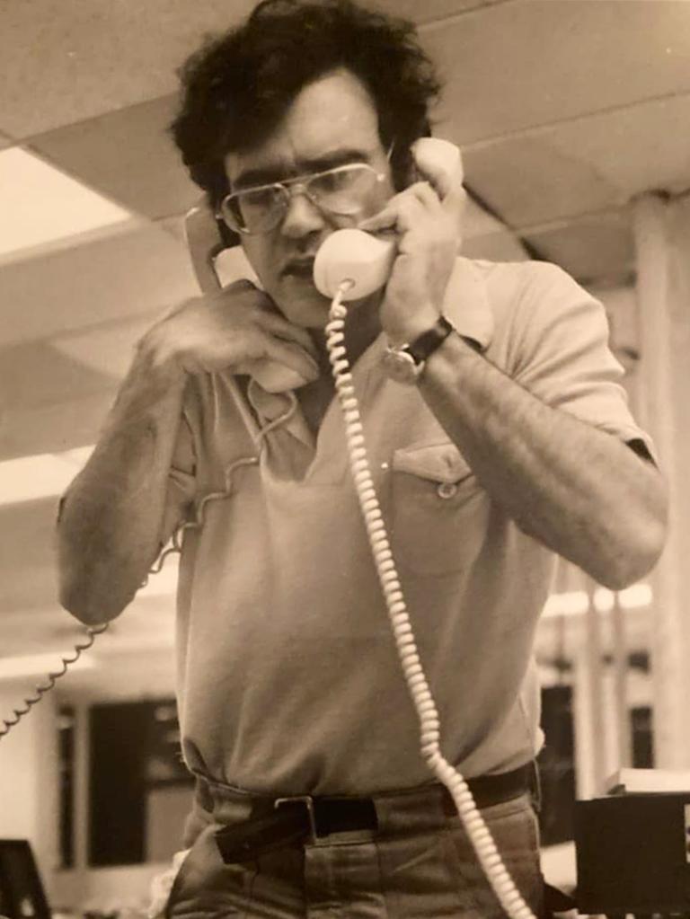 Mike Hechtman holding a telephone, known for mentoring young reporters