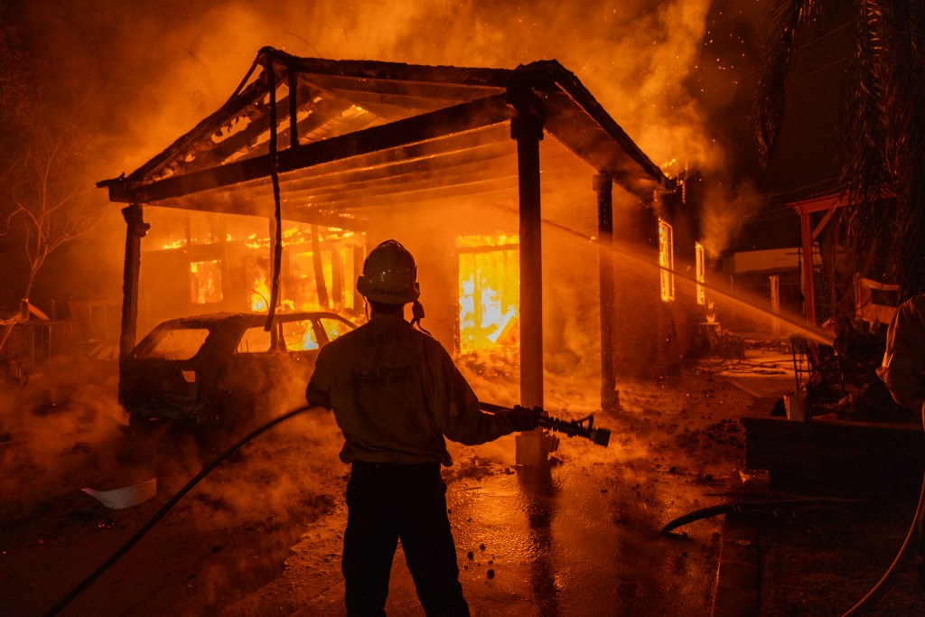Firefighters battle the Eaton Fire on January 8, 2025 in Altadena, California.