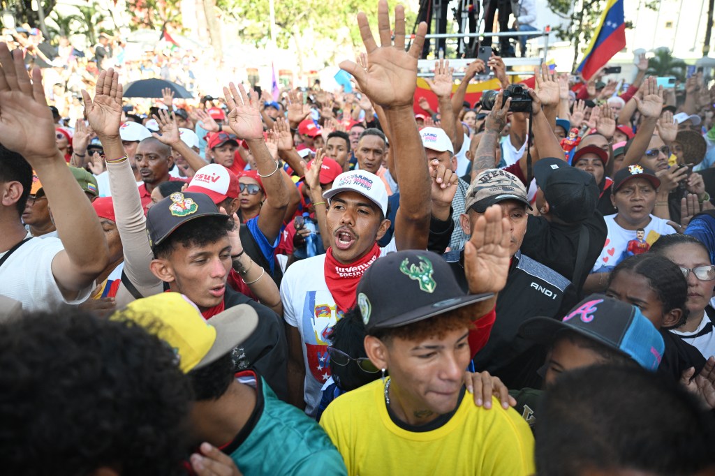 Supporters of Venezuela's President Nicolas Maduro gesturing during his speech at the Miraflores presidential palace in Caracas, Venezuela, for his third term inauguration in January 2025.