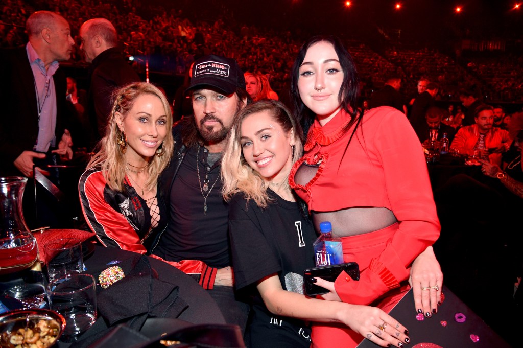 Tish Cyrus, Billy Ray Cyrus, Miley Cyrus, and Noah Cyrus posing at the 2017 iHeartRadio Music Awards