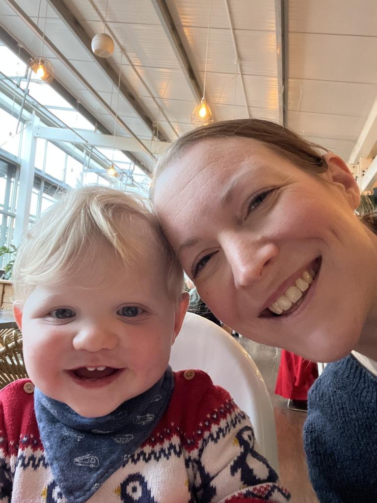 Zoe Gardner-Lawson and her young child grin as they take a selfie. 
