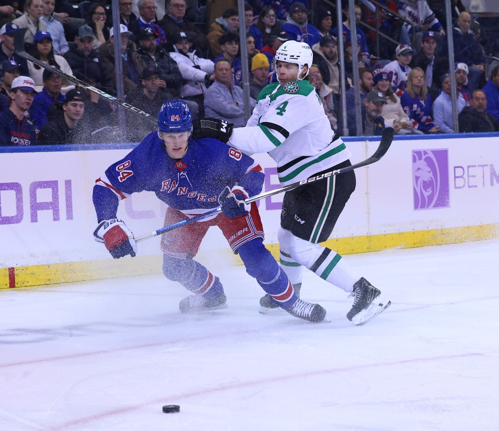 Dallas Stars defenseman Miro Heiskanen (4) checks New York Rangers center Adam Edstrom (84) as Edstrom chases the puck during the first period when the New York Rangers played the Dallas Stars Tuesday, January 7, 2025 