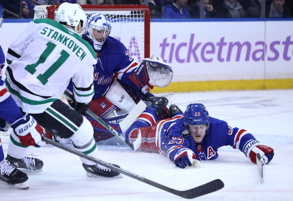 New York Rangers defenseman Adam Fox (23) dives in front of the puck