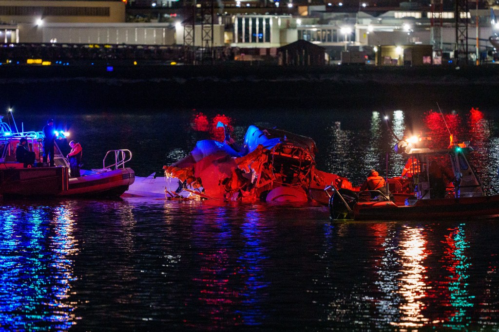 Emergency responders access the crash site of the plane near Ronald Reagan National Airport. 