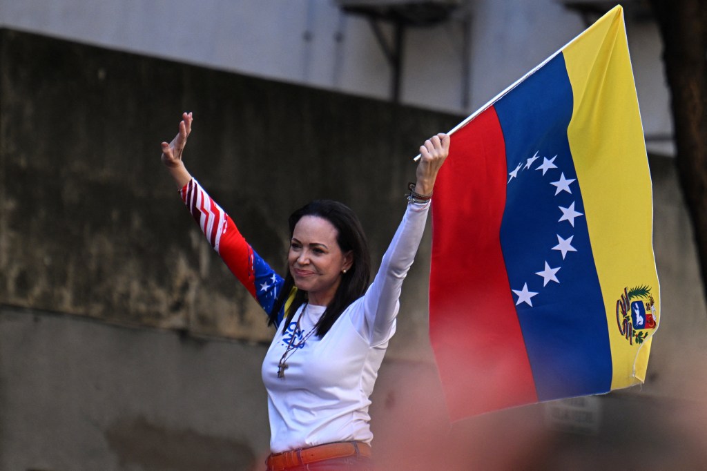 Venezuelan opposition leader Maria Corina Machado waving a national flag during a protest on the eve of the presidential inauguration in Caracas, January 9, 2025.