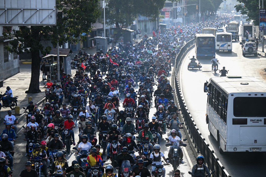 Supporters of Venezuelan President Nicolas Maduro on motorcycles at a rally in Caracas, days before Maduro's third consecutive term inauguration.