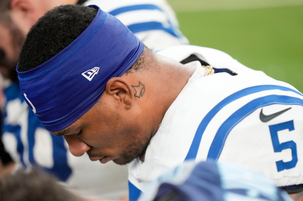 Indianapolis Colts quarterback Anthony Richardson (5) kneels in prayer after a game against the Tennessee Titans at Lucas Oil Stadium.