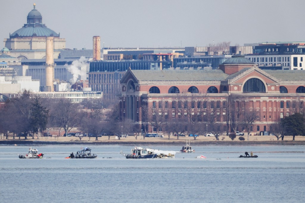 Search and rescue teams working at the crash site of American Eagle flight 5342 and a Black Hawk helicopter in the Potomac River