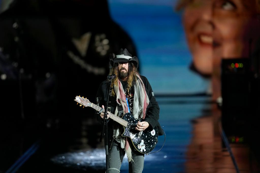 Billy Ray Cyrus performs, playing his guitar, at the Liberty Ball during the 60th Presidential Inauguration.