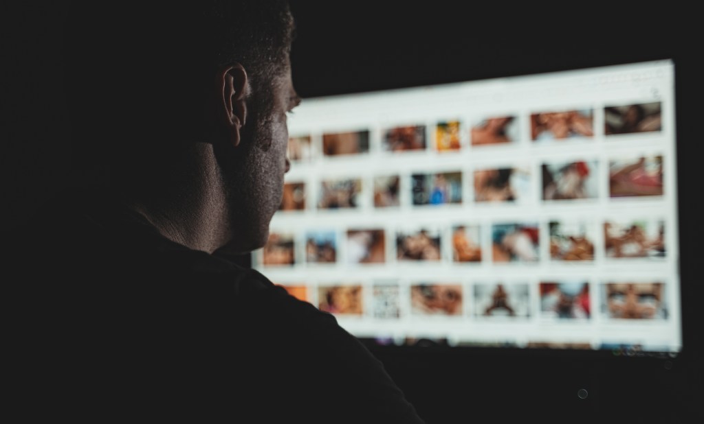 Man browsing porn site late at night.