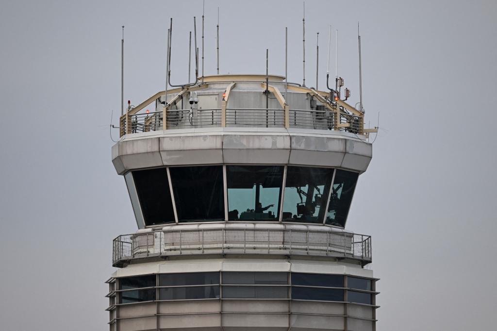 A man gestures inside the control tower of Reagan National Airport after an American Airlines flight crashed into the river after colliding with a US Army helicopter, near Washington, DC, on January 30, 2025.