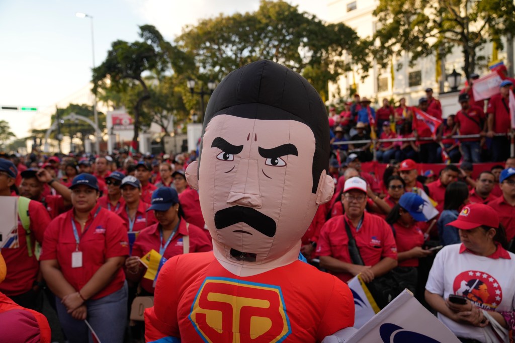 A person dressed as Super Mustache, symbolizing President Nicolas Maduro, among pro-government supporters at Miraflores Palace, ahead of Maduro's third term inauguration in Caracas, Venezuela