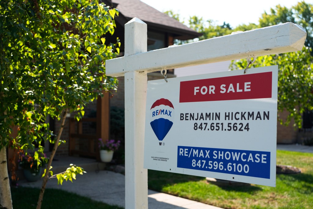 For sale sign in front of home