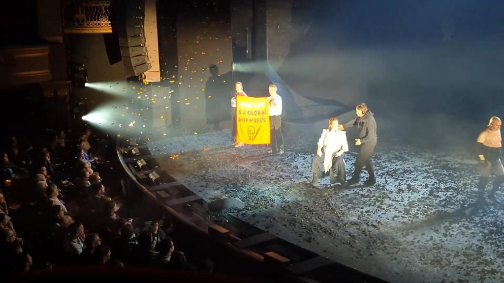 Sigourney Weaver leaving stage following interruption by Just Stop Oil protesters brandishing a confetti cannon and sign during a performance of The Tempest in London's West End.