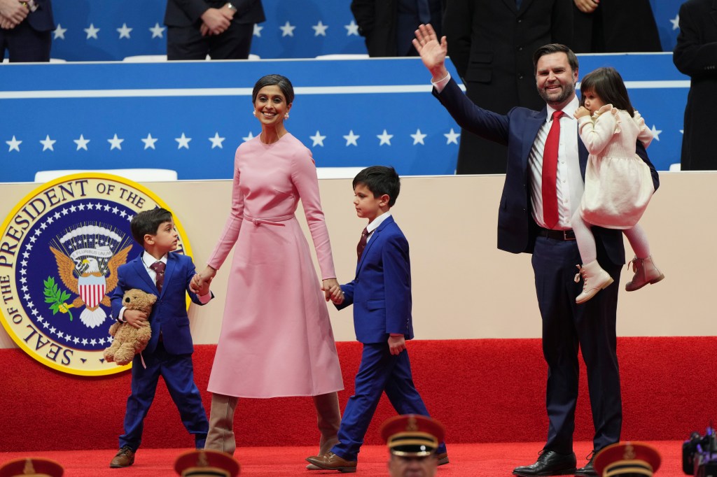 Usha and JD Vance walk with their children.