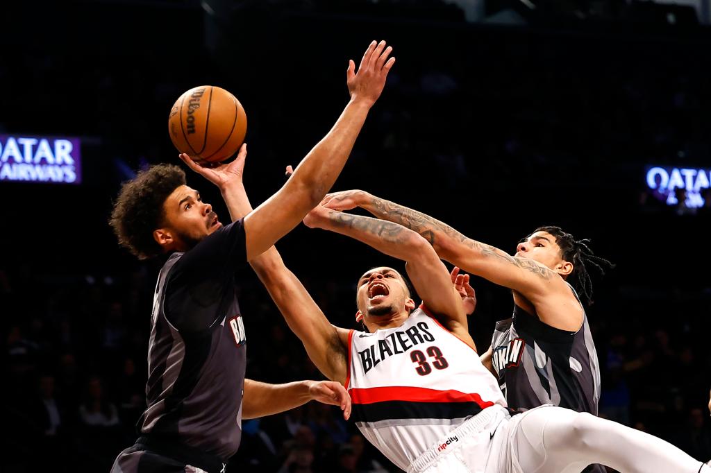 Portland Trail Blazers forward Toumani Camara (33) drives to the basket against Brooklyn Nets forward Cameron Johnson (2) and guard Killian Hayes (7) during the first half at the Barclays Center.