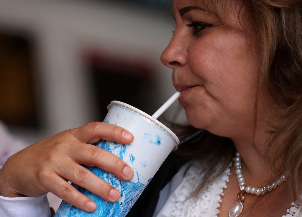 A customer at Wipeout Bar & Grill uses a paper straw in her drink on June 21, 2018 in San Francisco, California. 
