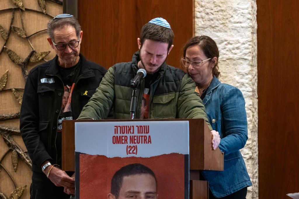 Parents Ronen and Orna Neutra, with their son Daniel, speaking at a memorial service for their fallen son, Omer Neutra, at the Midway Jewish Center in Syosset, New York.