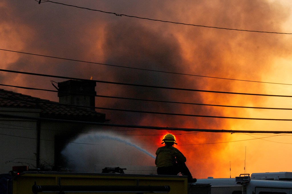 A firefighter battling the Palisades Fire during a windstorm on the west side of Los Angeles, California on January 8, 2025.