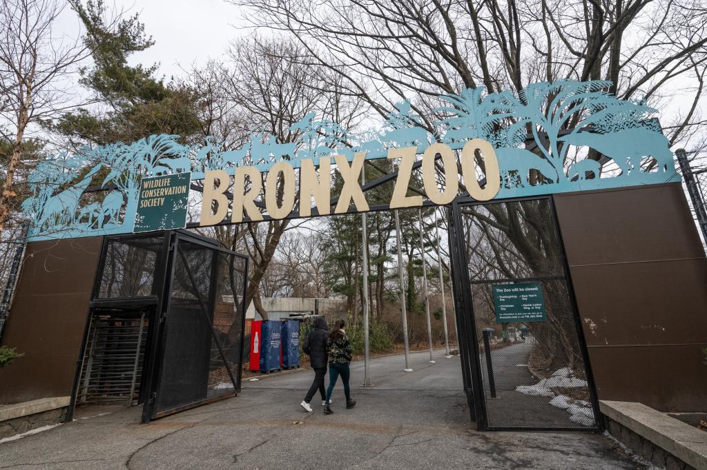 Entrance to the Bronx Zoo located at Bronx Park, seen with families with kids seen out front.