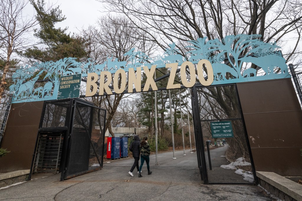 Entrance to the Bronx Zoo located at Bronx Park, seen with families with kids seen out front.